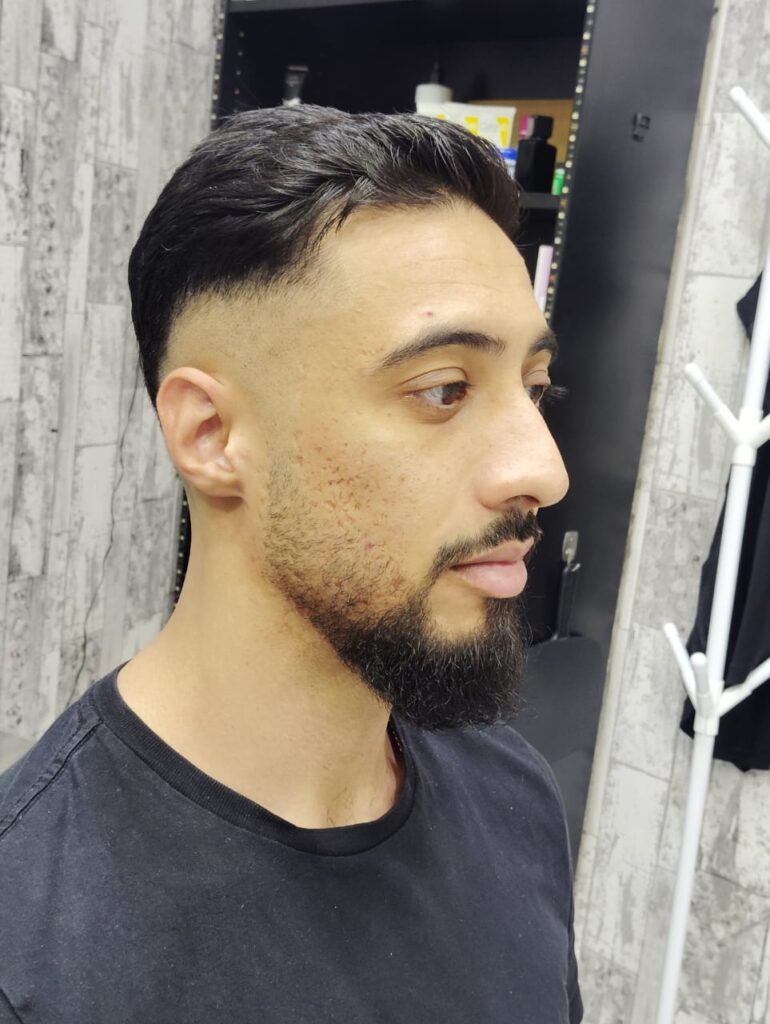 Professional taper haircut styling in Al Rigga